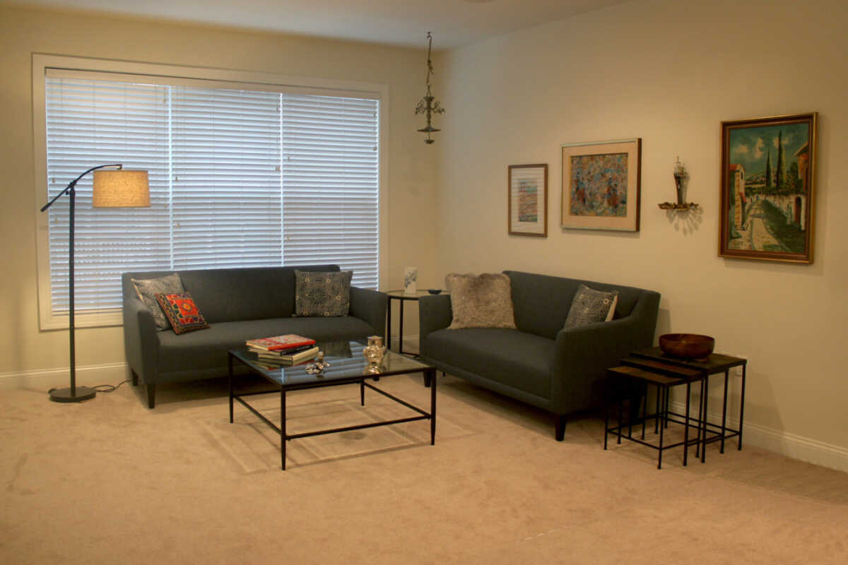 Hanging art in Blue and Beige living room